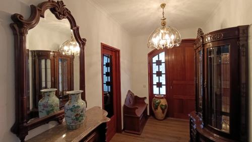 a room with a mirror and vases on a table at Orion Guest Villa Casais in Lousada