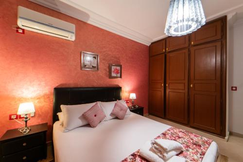 a bedroom with a white bed with red walls at villa Rita chaouen in Chefchaouen