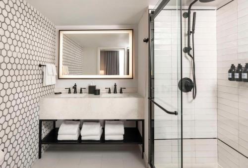 a bathroom with a sink and a shower at Mills House Charleston, Curio Collection by Hilton in Charleston