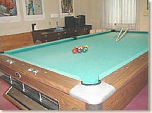 a pool table in a living room with at Hotel Weisser Hof Happei in Hakuba