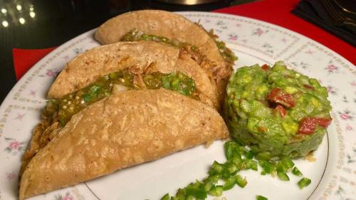 a white plate with two sandwiches and green peas at Hotel Black Boutique in Mexico City