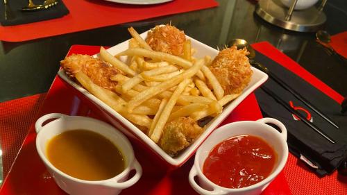 a tray of food with french fries and dipping sauce at Hotel Black Boutique in Mexico City