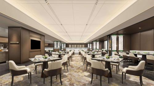 a large dining room with tables and chairs at Yuexiu Hotel Guangzhou Curio Collection By Hilton, Free Shuttle during Canton Fair in Guangzhou