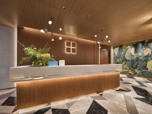 a lobby with a reception desk in a building at Hilton Garden Inn Hangzhou West Lake in Hangzhou