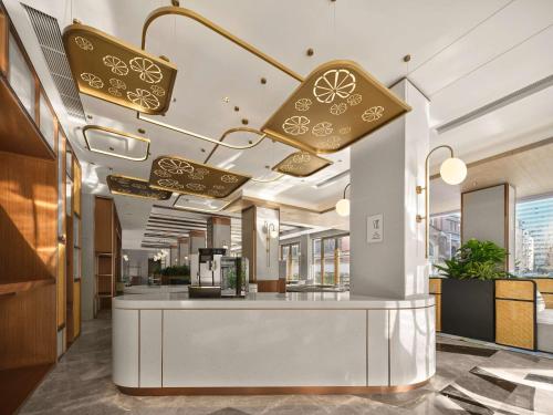 a lobby with a counter in a building at Hilton Garden Inn Hangzhou West Lake in Hangzhou