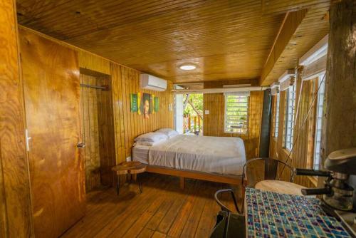 a bedroom with a bed in a wooden room at Ocean Front Villa 4 Studio in Culebra