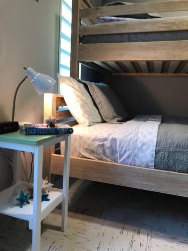 a bedroom with a bed and a table with a lamp at Ocean Front Villa 1 in Culebra