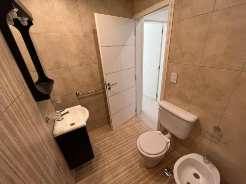 a small bathroom with a toilet and a sink at Departamento nuevo en San Bernardo in San Bernardo