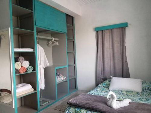 a bedroom with a blue bunk bed and shelves at Maui's View in Santa Elena