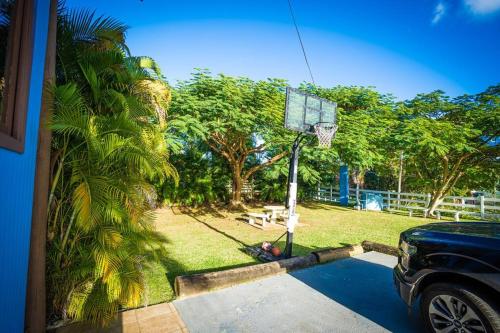 a car parked in a driveway with a basketball hoop at Villa Tesoro at Carabali in Luquillo