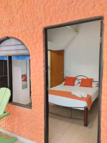 a bedroom with a bed and a mirror at La Rivera Playa Palomino in Palomino