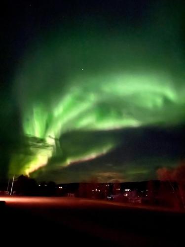 an aurora in the sky over a city at Hótel Eyjafjallajökull in Hvolsvöllur