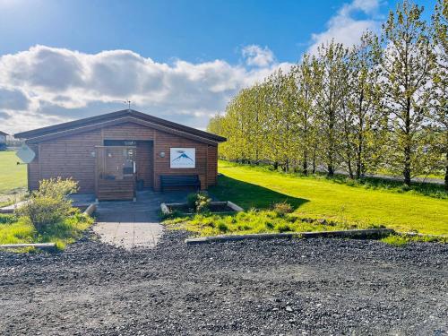 a small building with a door on a field at Hótel Eyjafjallajökull in Hvolsvöllur