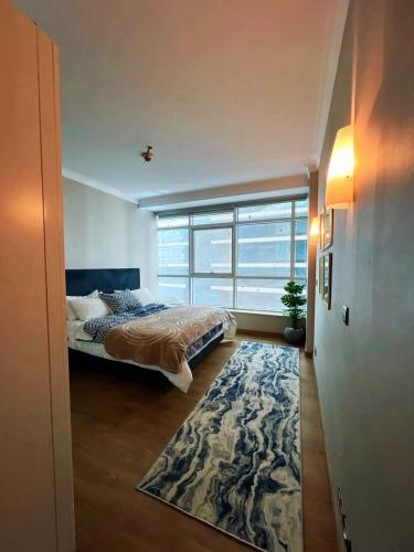 a bedroom with a bed and a large window at شقة فندقية - كورنيش المعادي تاور ريزيدنت in Cairo