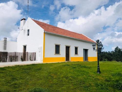 a white church with a red roof at Quinta da Casa Azul in Óbidos