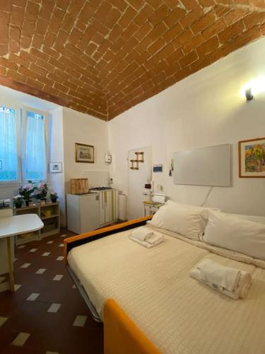 a bedroom with a large bed with a brick ceiling at George’s House in Florence