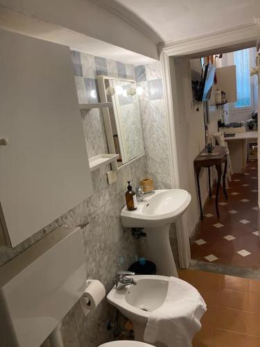 a bathroom with a sink and a toilet and a mirror at George’s House in Florence