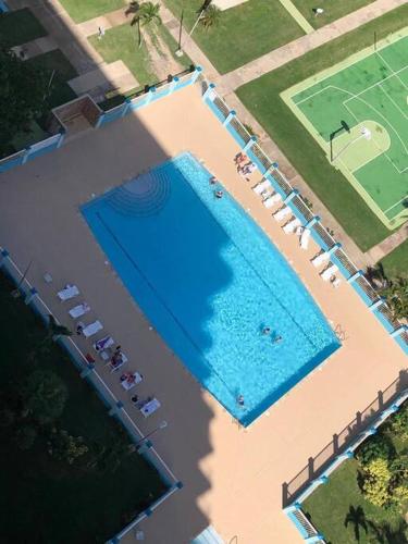 an overhead view of a large swimming pool with chairs at Enchanted Jewel 39 Beachfront Pool in Luquillo