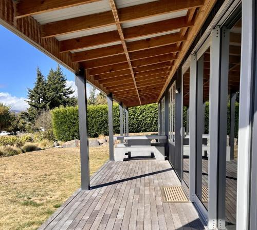 a wooden porch with awning on a house at D'Archiac Cottage - Lake Tekapo in Lake Tekapo