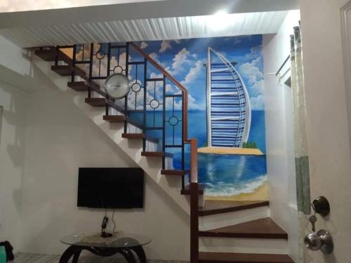 a mural of a staircase with a view of the ocean at Al Manzil in General Santos