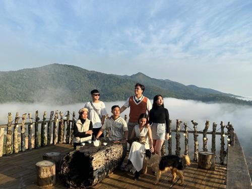 a group of people posing for a picture on a pier at THIÊN HƯƠNG Homestay Măng Đen in Kon Von Kla