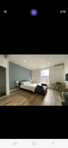 een grote slaapkamer met een bed en een raam bij Le Bon Plan in Montreal