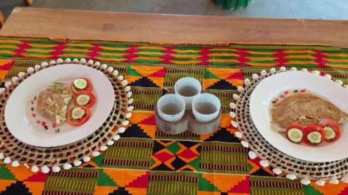 two plates of food sitting on top of a table at MANGROVE BEACH in Sanyang