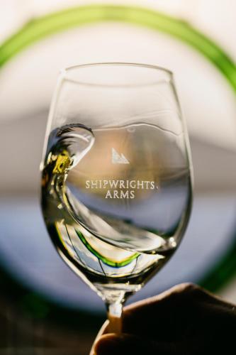 a person holding up a glass of wine at Shipwrights Arms Hotel in Hobart