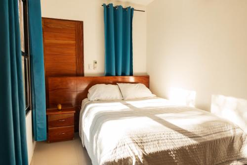 a bedroom with a bed with a blue curtain at Summer Deals! 800M to Samara Beach 2 BDR in Sámara