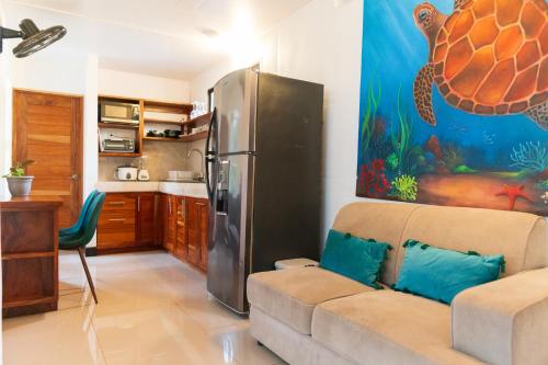 a living room with a couch and a refrigerator at Summer Deals! 800M to Samara Beach 2 BDR in Sámara