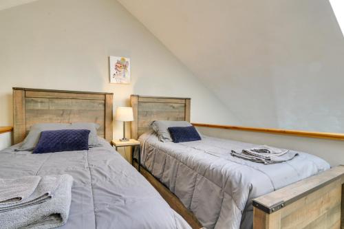 two beds sitting next to each other in a room at Somerset Townhome with Deck Less Than 2 Mi to Ski Lift! in Champion