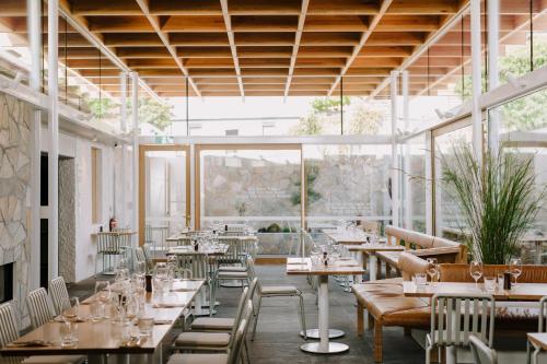 a restaurant with tables and chairs and windows at Shipwrights Arms Hotel in Hobart