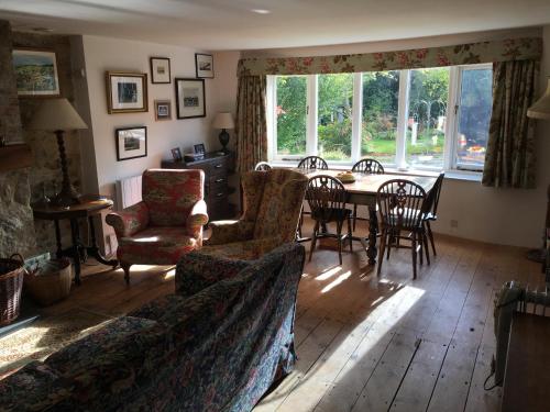 a living room with a couch and a table and chairs at Tawleat in Okehampton