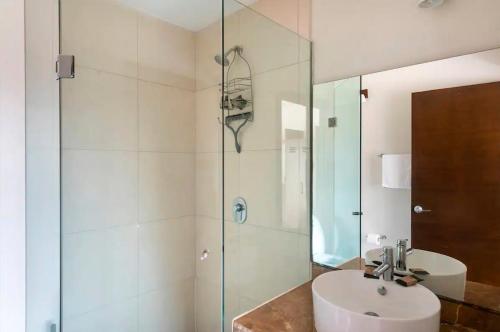 a bathroom with a sink and a glass shower at Departamento en Nuevo Vallarta in Nuevo Vallarta