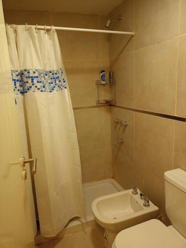 a bathroom with a shower and a toilet and a sink at Moderno Mono Ambiente céntrico in Santiago del Estero