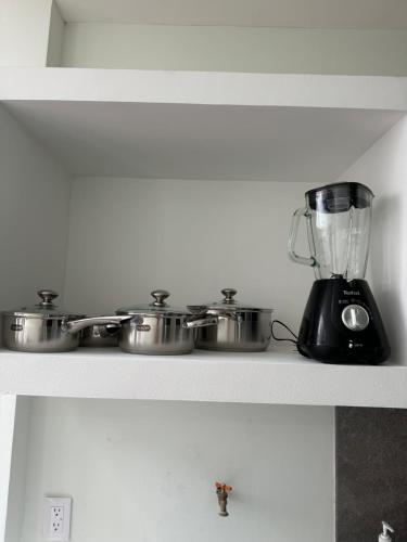 a kitchen counter with a blender and pots and pans at Departamento PYO in Mexico City