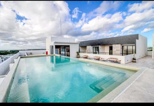 a large swimming pool on the roof of a house at Musa 318 in Playa del Carmen