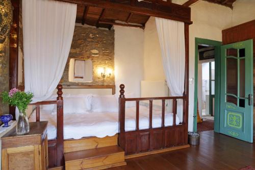 a bedroom with a canopy bed with white sheets at Nisanyan Hotel in Selcuk