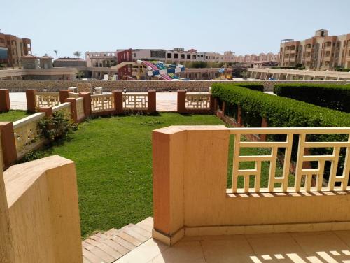 a park with a wooden fence and green grass at Nozha Beach - Ras Sudr in Ras Sedr