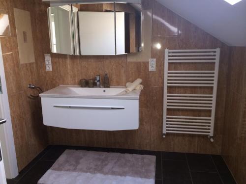 a bathroom with a sink and a mirror at Leiner Apartman in Hévíz