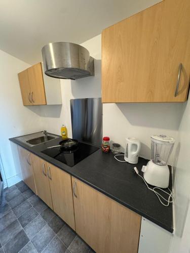 a kitchen with a counter top and a blender at Crete home in Oldham