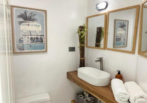 a bathroom with a sink on a wooden counter at Bahiamar in Pampatar