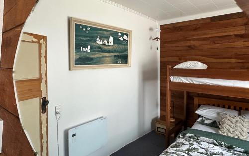 a bedroom with a bunk bed and a mirror at Kahu's Nest in Hokitika