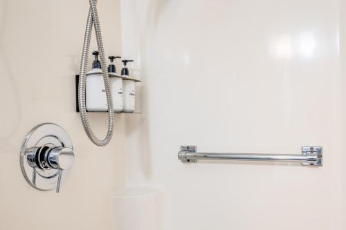 a bathroom with a shower head and a sink at Oxford Apartment by At Mine Hospitality in Seattle
