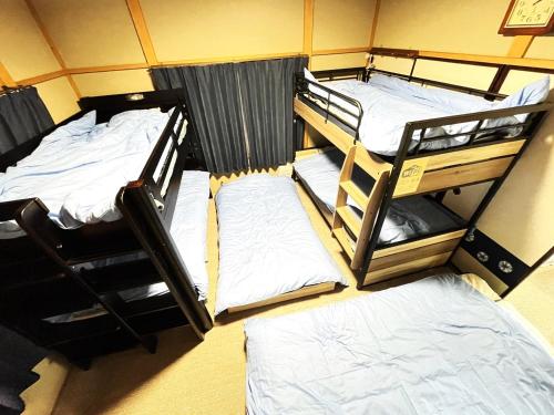 a group of three bunk beds in a room at Nikko World Heritage STAY【日光山内】一棟丸貸しの宿 in Nikko
