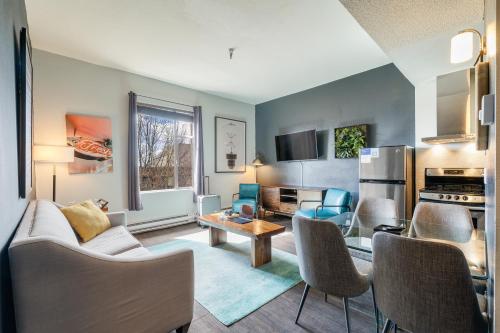 a living room with a couch and a table at Oxford Apartment by At Mine Hospitality in Seattle