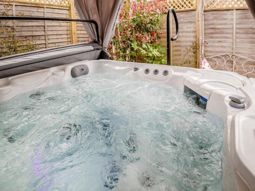 a jacuzzi tub in a backyard at Dukes House in Corsham