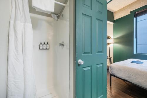 a green door in a bedroom with a bed at Oxford Apartment by At Mine Hospitality in Seattle