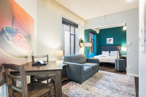 a living room with a desk and a bedroom at Oxford Apartment by At Mine Hospitality in Seattle