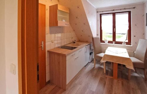 a small kitchen with a sink and a table at 1 Bedroom Amazing Apartment In Altenkirchen Auf Rgen in Altenkirchen